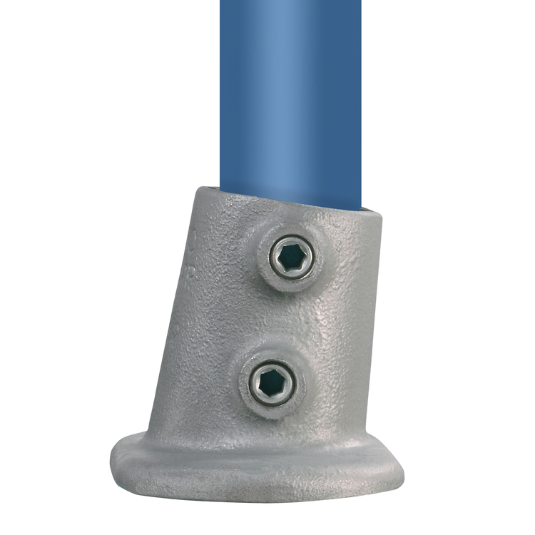 Fußplatte Typ 12S – variabler Winkel für leichte Rohrneigungen Fußplatte Typ 12S aus Gusseisen, mit variablem Winkel für leichte Rohrneigungen. Die graue Fußplatte hält ein blaues Rohr schräg und zeigt zwei Innensechskantschrauben.